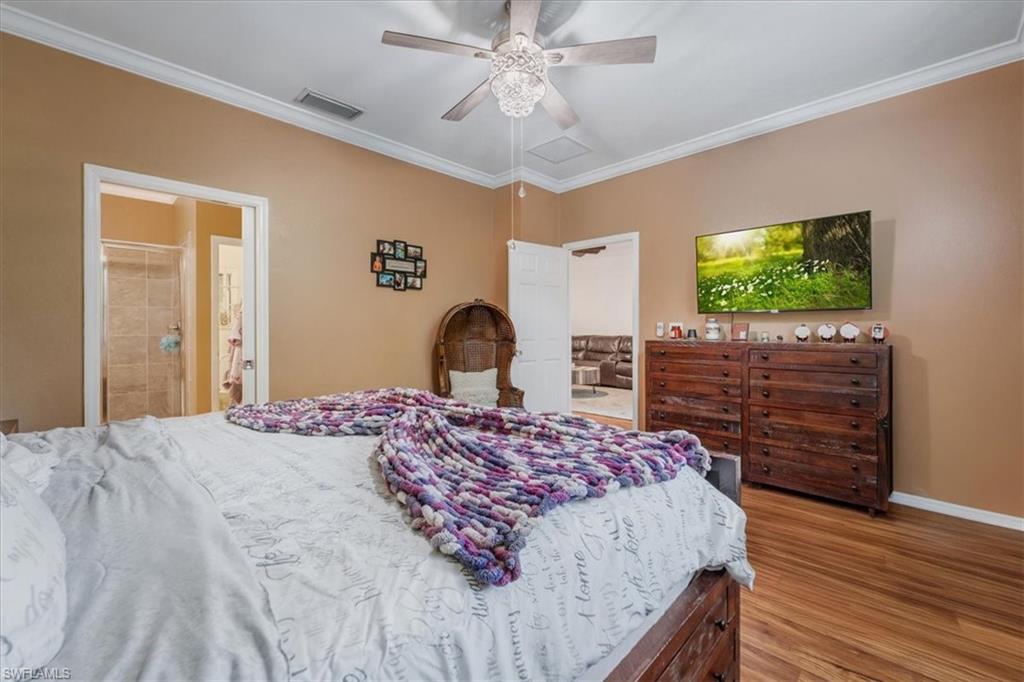 9052 Glenforest Drive Naples, FL 34120 - Photo 14 of 20 a bedroom with a bed and a flat screen tv