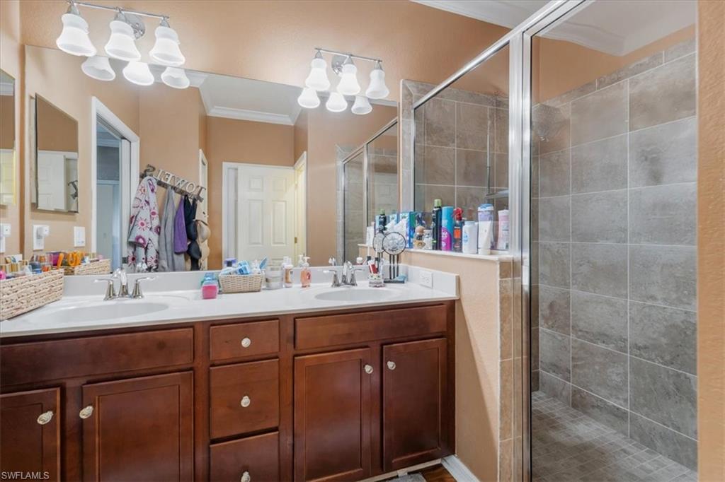 9052 Glenforest Drive Naples, FL 34120 - Photo 16 of 20 a bathroom with a sink vanity granite and a mirror