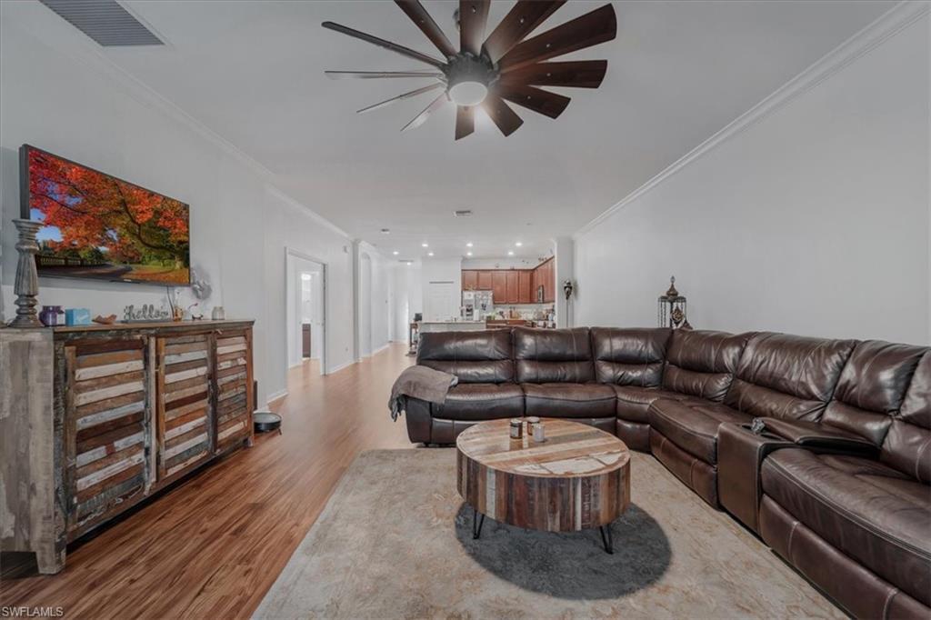 9052 Glenforest Drive Naples, FL 34120 - Photo 18 of 20 a living room with furniture and a flat screen tv
