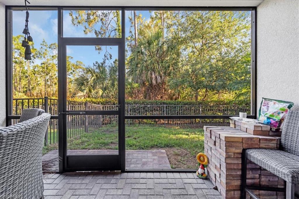 9052 Glenforest Drive Naples, FL 34120 - Photo 20 of 20 a view of a porch with furniture and garden