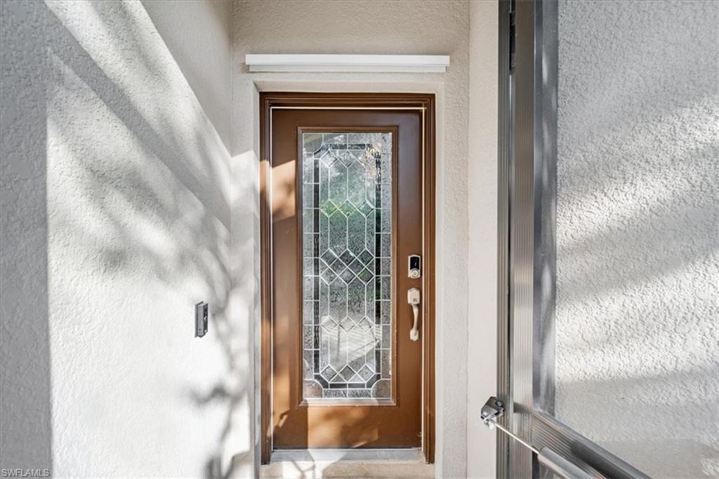 9052 Glenforest Drive Naples, FL 34120 - Photo 2 of 20 a view of a wooden door