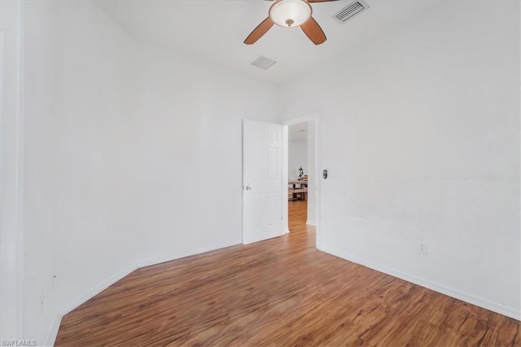 9052 Glenforest Drive Naples, FL 34120 - Photo 10 of 20 a view of empty room with wooden floor