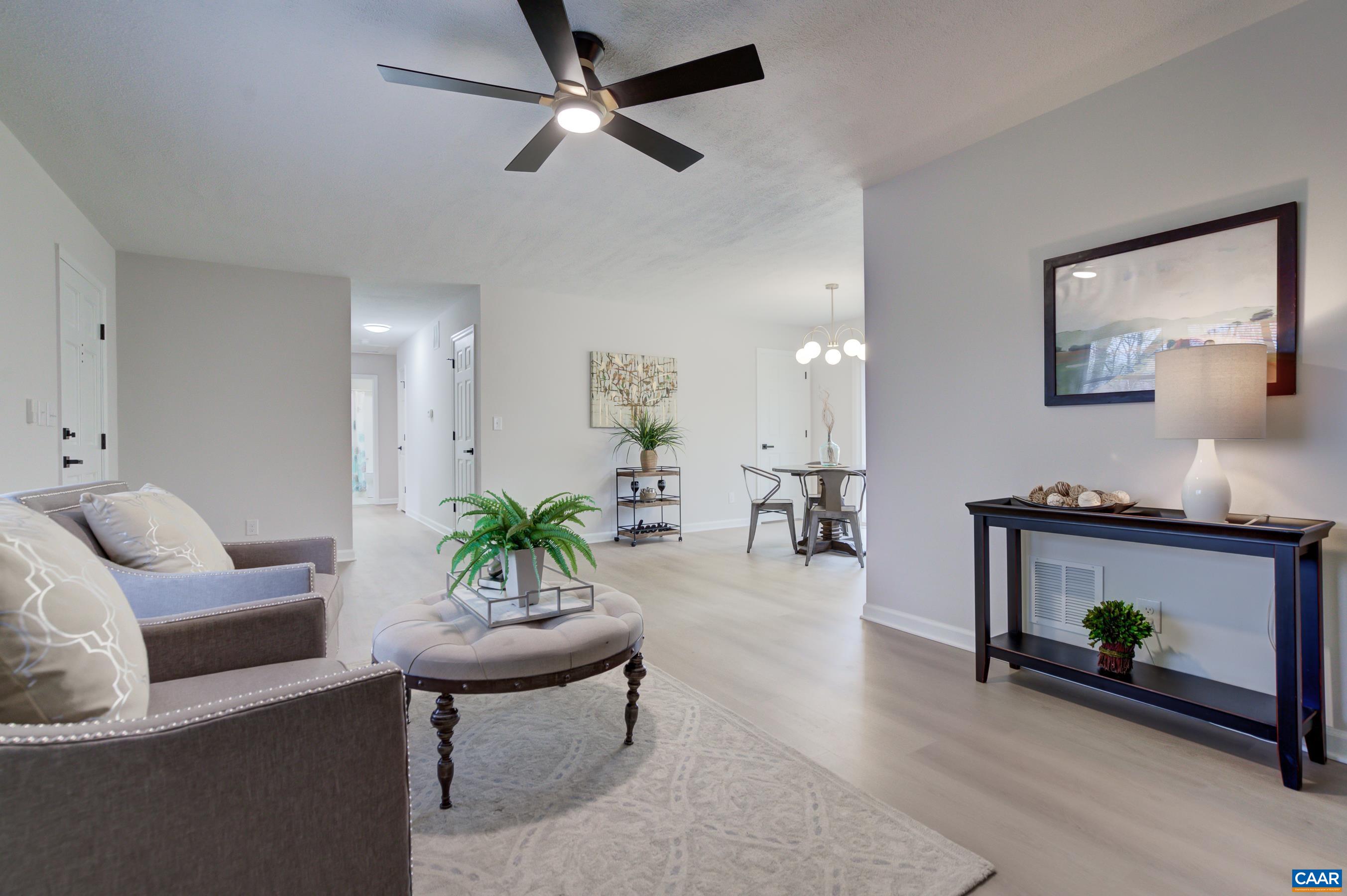 5582 Brookwood Road Crozet, VA 22932 - Photo 11 of 61 a living room with furniture a fireplace and a potted plant