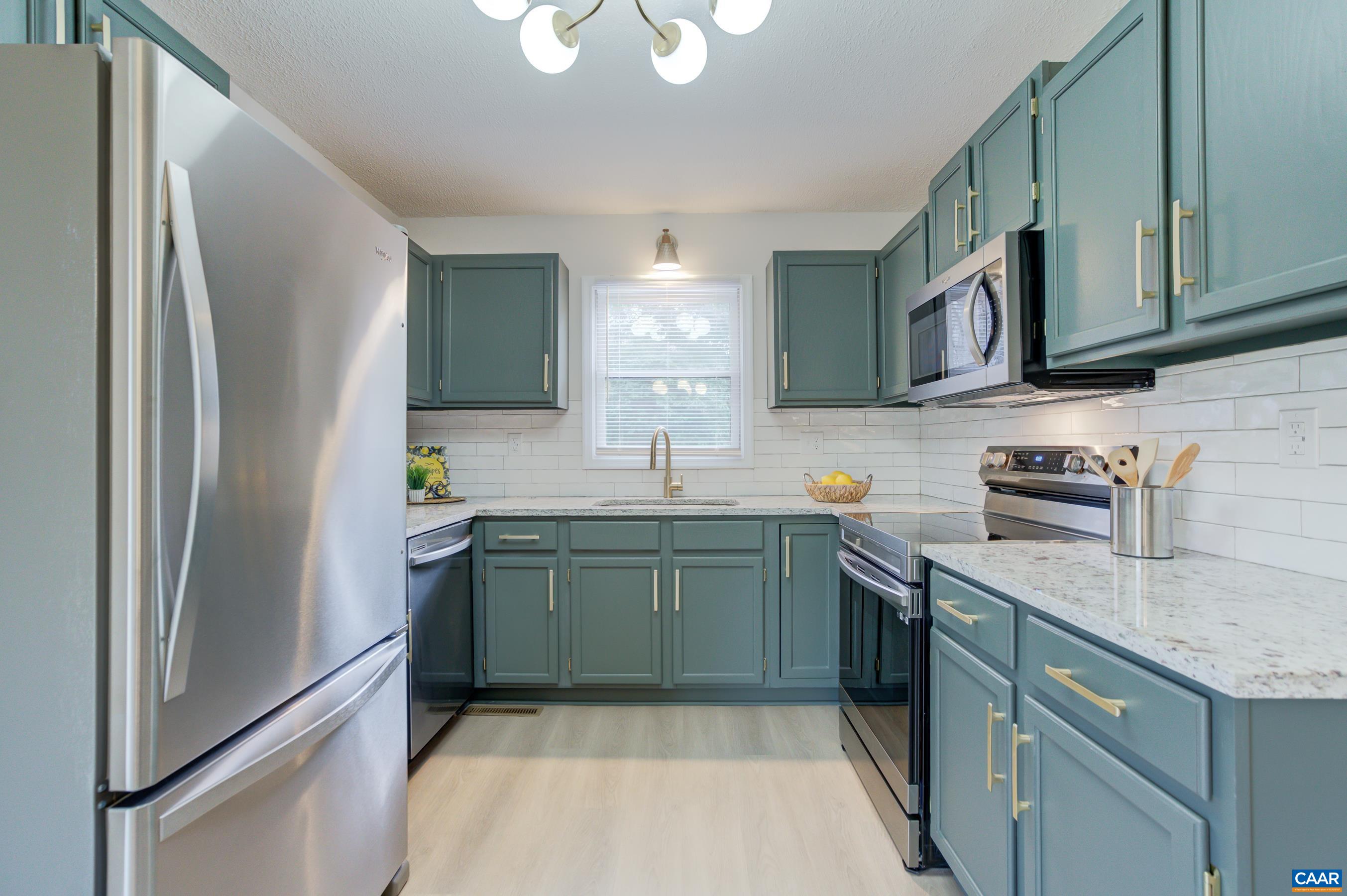 5582 Brookwood Road Crozet, VA 22932 - Photo 14 of 61 a kitchen with stainless steel appliances granite countertop a refrigerator sink and stove
