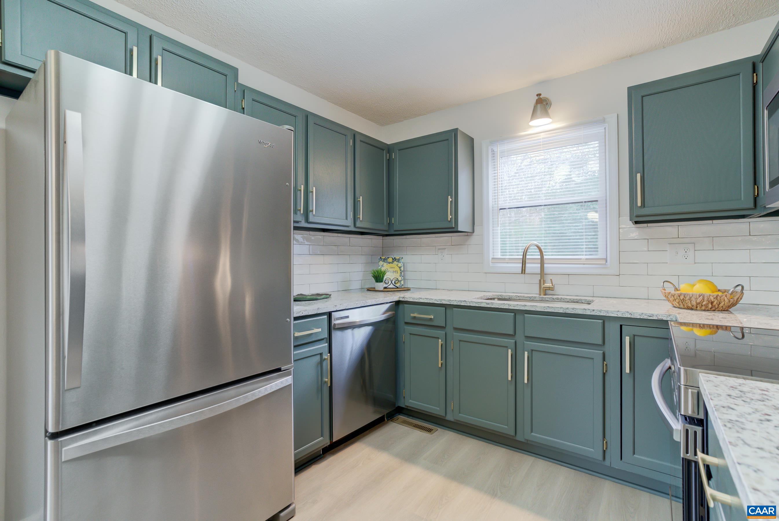 5582 Brookwood Road Crozet, VA 22932 - Photo 15 of 61 a kitchen with stainless steel appliances granite countertop a refrigerator and a sink