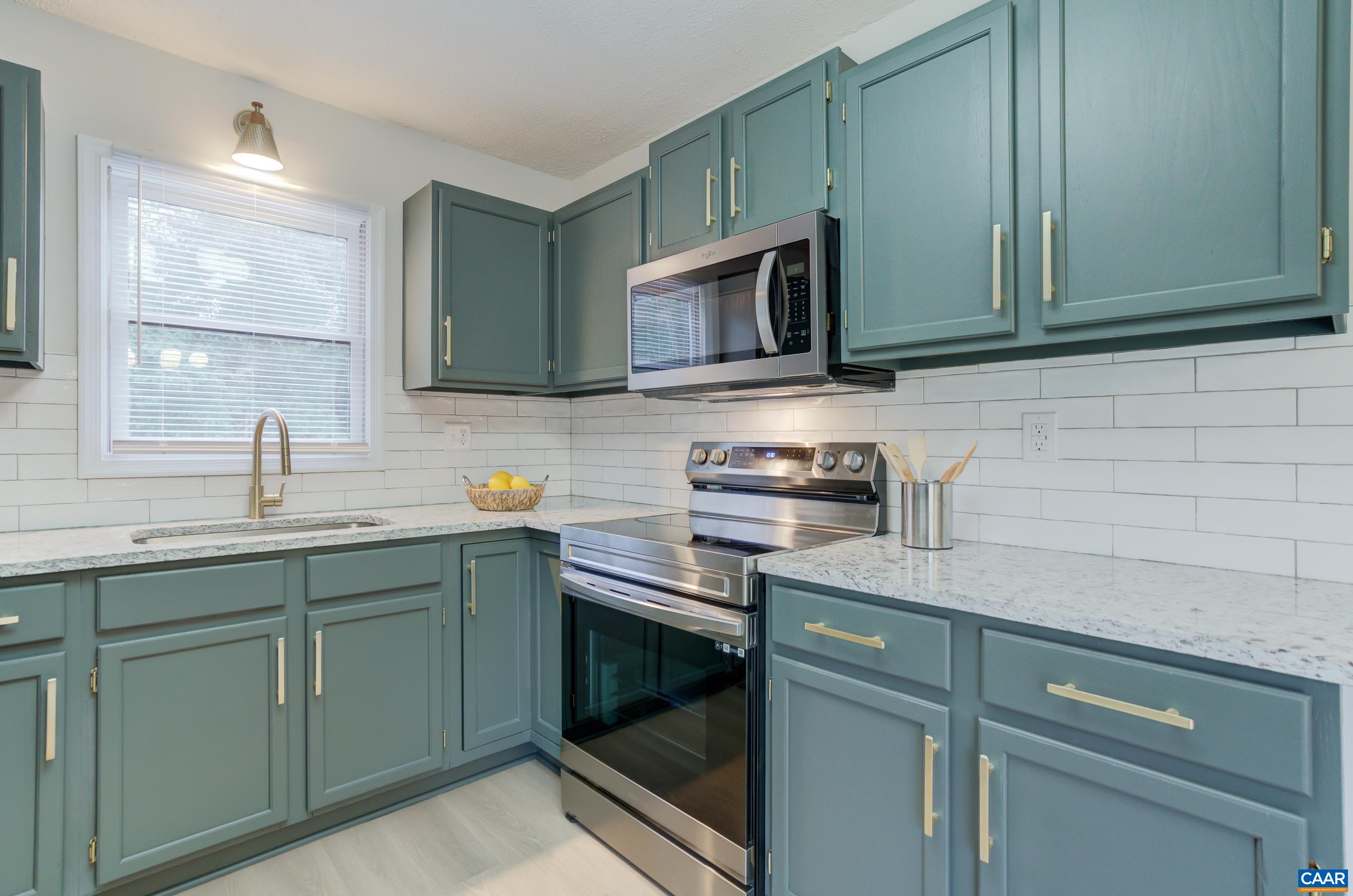 5582 Brookwood Road Crozet, VA 22932 - Photo 16 of 61 a kitchen with stainless steel appliances granite countertop a sink stove and microwave