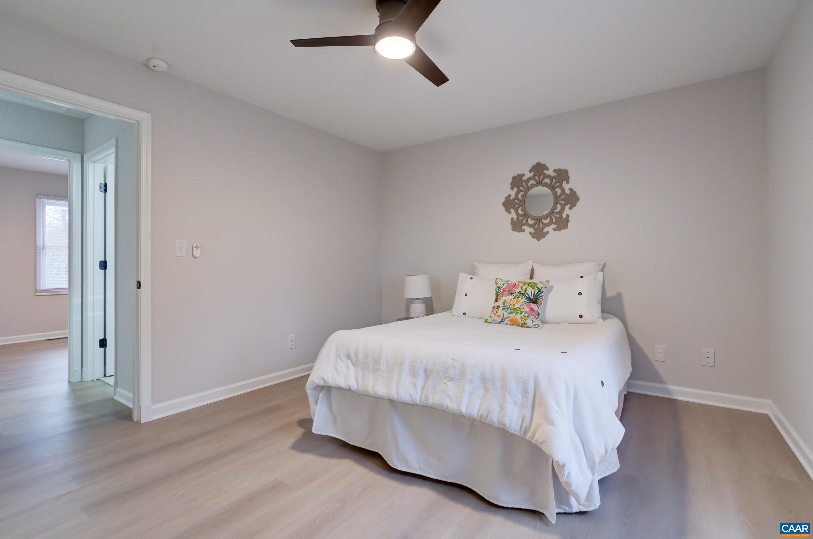 5582 Brookwood Road Crozet, VA 22932 - Photo 19 of 61 a bedroom with a bed and wooden floor