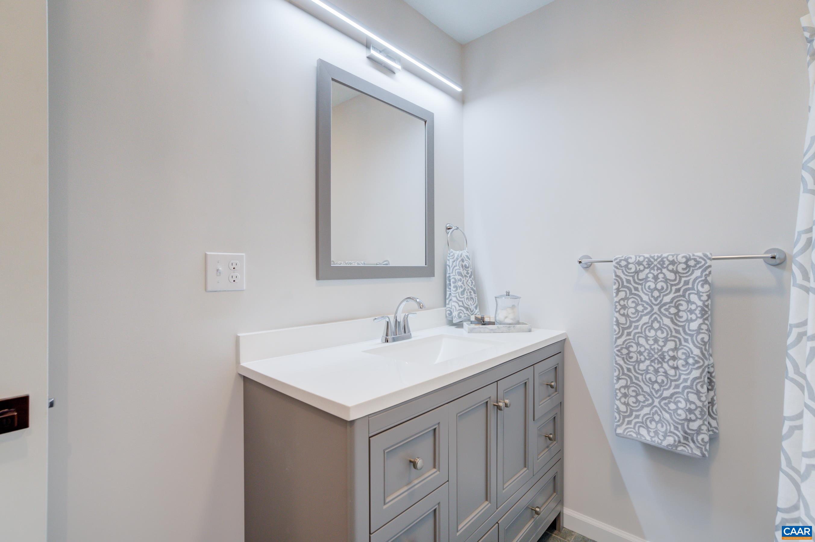 5582 Brookwood Road Crozet, VA 22932 - Photo 21 of 61 a bathroom with a sink and a mirror