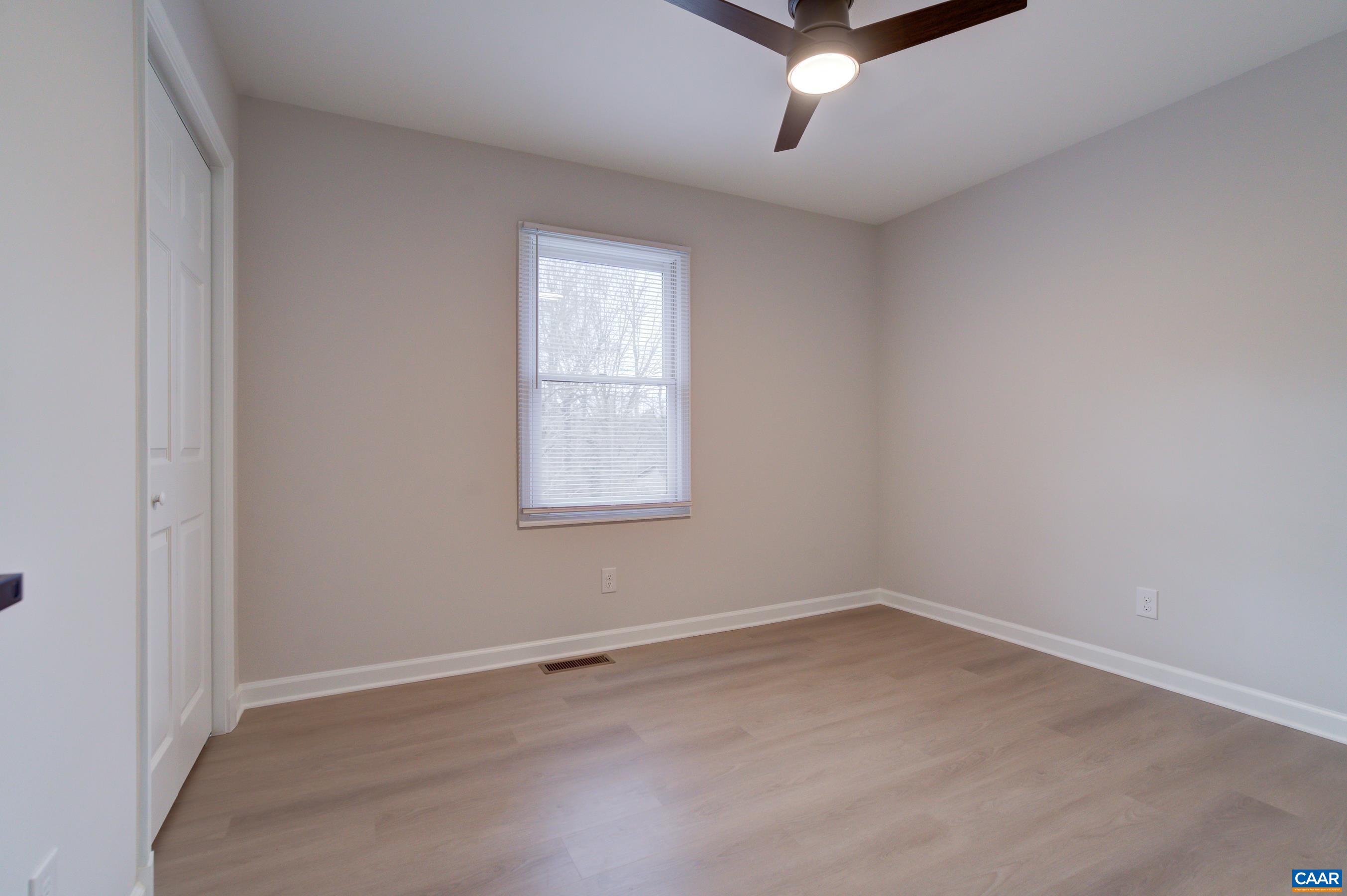 5582 Brookwood Road Crozet, VA 22932 - Photo 24 of 61 an empty room with a ceiling fan and window