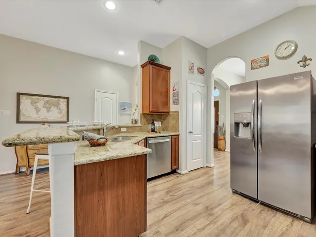 a kitchen with a refrigerator and a sink