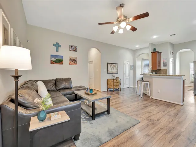 a living room with furniture and kitchen view