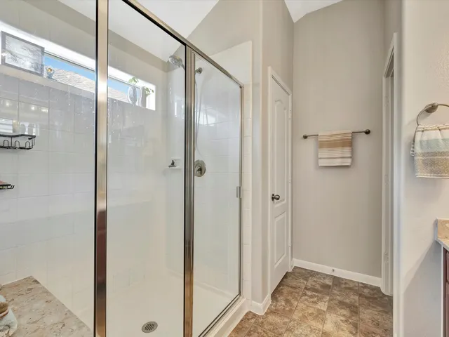 a bathroom with a shower and a sink