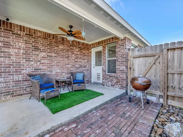 a backyard of a house with seating area and fire pit