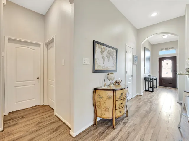 a view of a hallway to a house and wooden floor