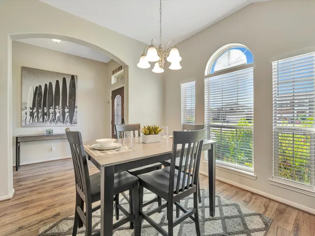 a view of a dining room with furniture window and wooden floor