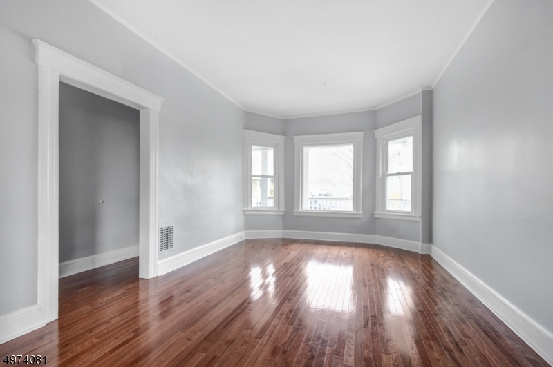 558 Summit Avenue, Unit 1 Westfield, NJ 07090 - Photo 11 of 13 a view of empty room with wooden floor and fan