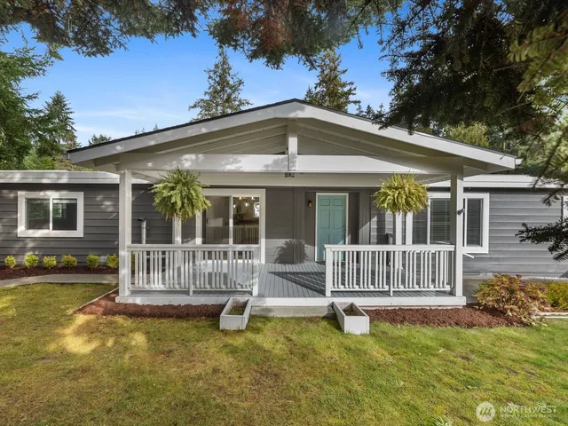a view of a house with a swimming pool and porch with furniture