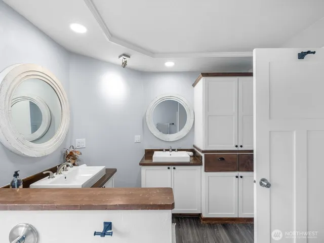 a bathroom with a sink mirror vanity and toilet