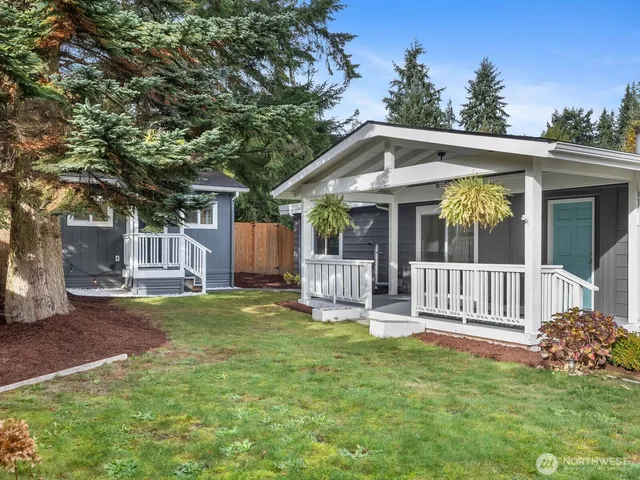 a front view of a house with a garden