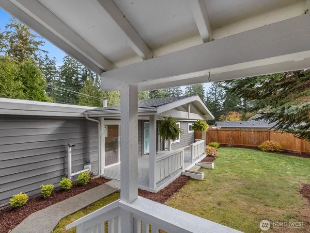 a view of a porch with furniture and garden