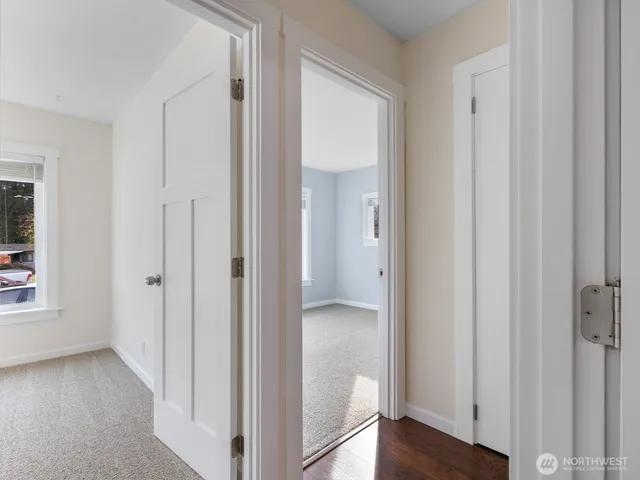 a view of a hallway with wooden floor