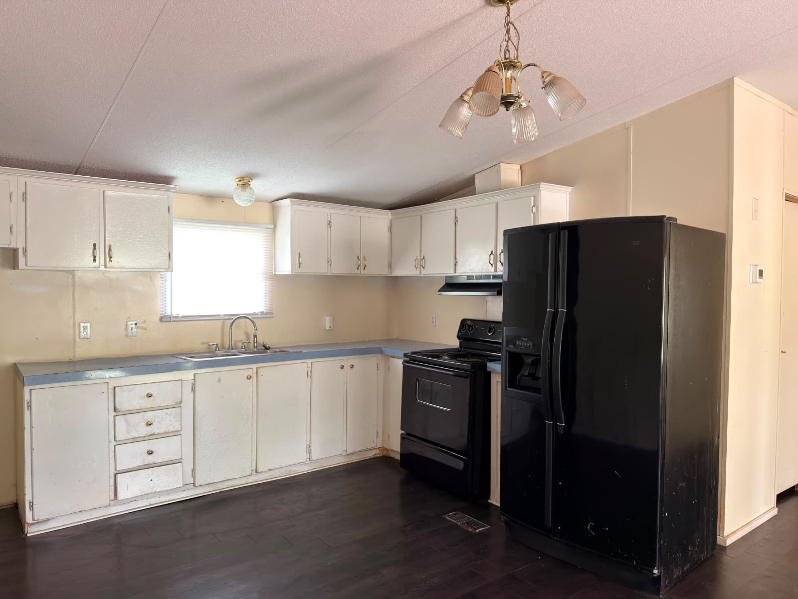 8607 Burleson Manor Road, Unit A Manor, TX 78653 - Photo 3 of 13 A functional kitchen provides ample storage and essential appliances.