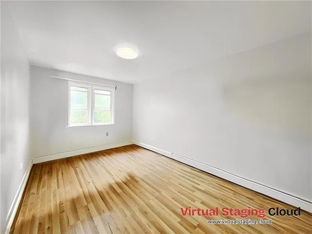 a view of an empty room and wooden floor