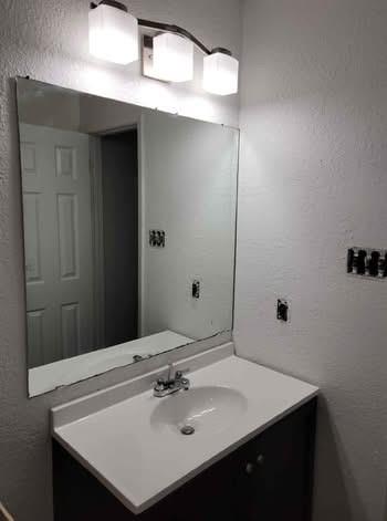 261 Audrey Avenue Waco, TX 76705 - Photo 11 of 11 a bathroom with a sink and a mirror