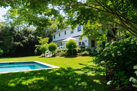 a view of a backyard with swimming pool