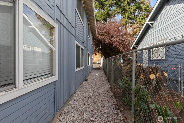 a view of a pathway of a house with wooden floor and floor to ceiling window