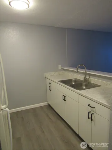 a room with a sink and cabinets