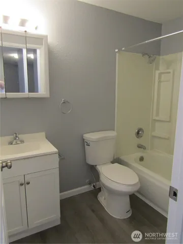 a white toilet sitting next to a bathroom sink