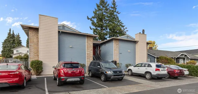 a view of cars parked in front of a house