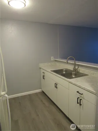 a room with a sink and cabinets