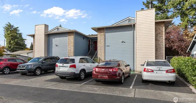 a couple of cars parked in front of a house