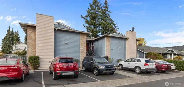 a view of cars parked in front of a house