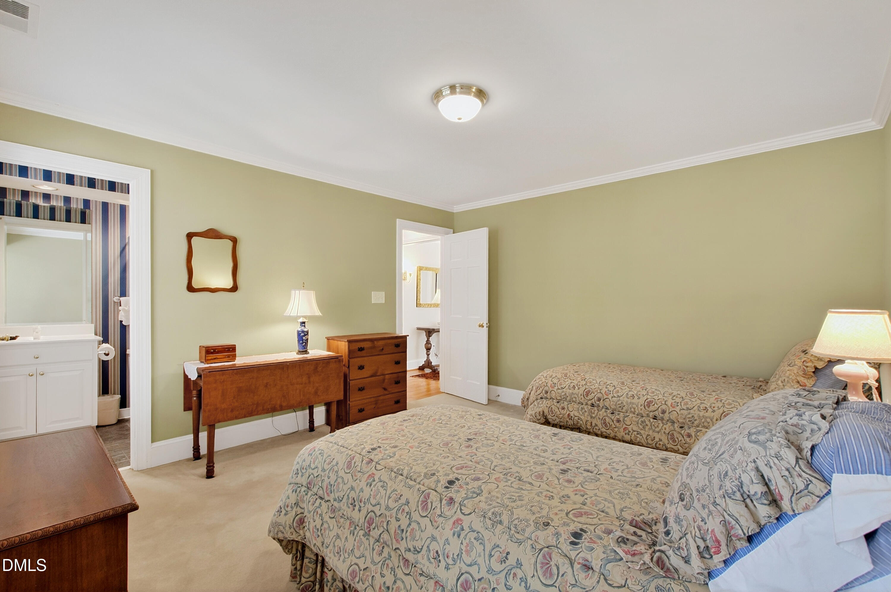 3708 Lubbock Drive Raleigh, NC 27612 - Photo 46 of 64 a bedroom with a bed and a table in it