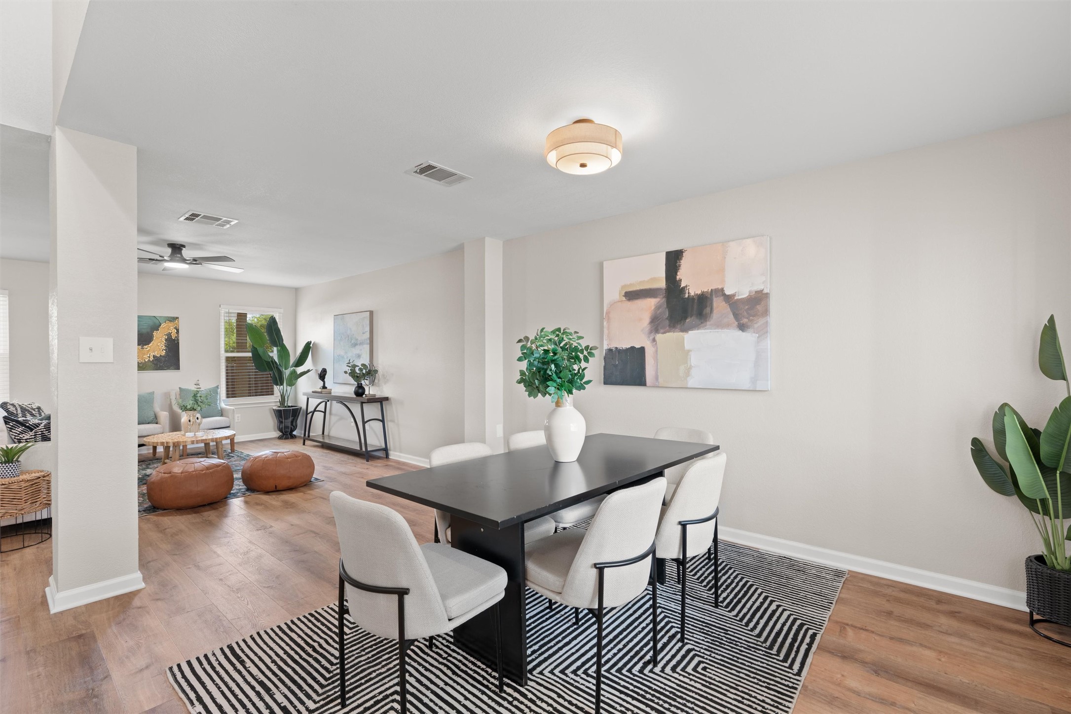 724 Lavaca Loop Elgin, TX 78621 - Photo 5 of 40 Smooth wood floors flow seamlessly through this open concept dining area and living room space.