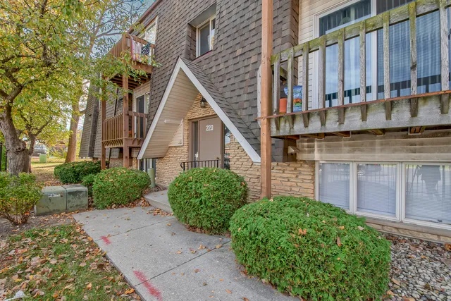 a view of a house with a small yard and plants