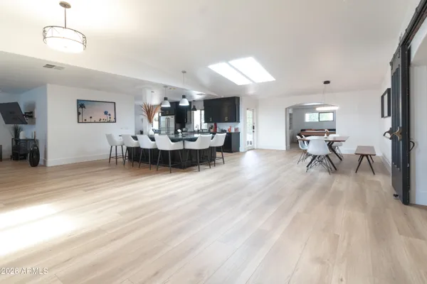 a bedroom with a bed and a flat tv screen on dresser