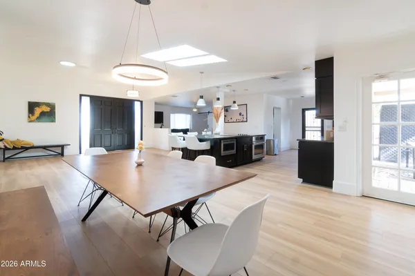 a room with pool table and windows