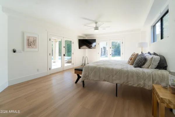 a bedroom with a bed and a flat tv screen on the dresser