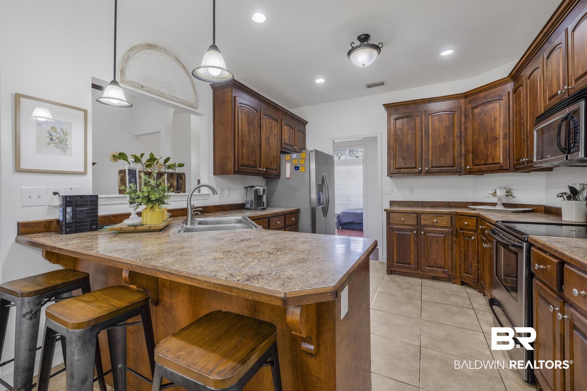 35814 Delvan Lane Bay Minette, AL 36507 - Photo 3 of 53 Kitchen featuring wood cabinetry, stone-finish countertops, and stainless steel appliances