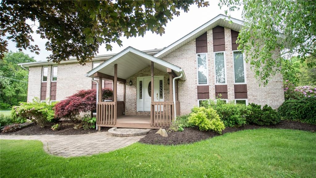 141 Singleton Road Sarver, PA 16055 - Photo 1 of 23 a front view of a house with a garden and plants
