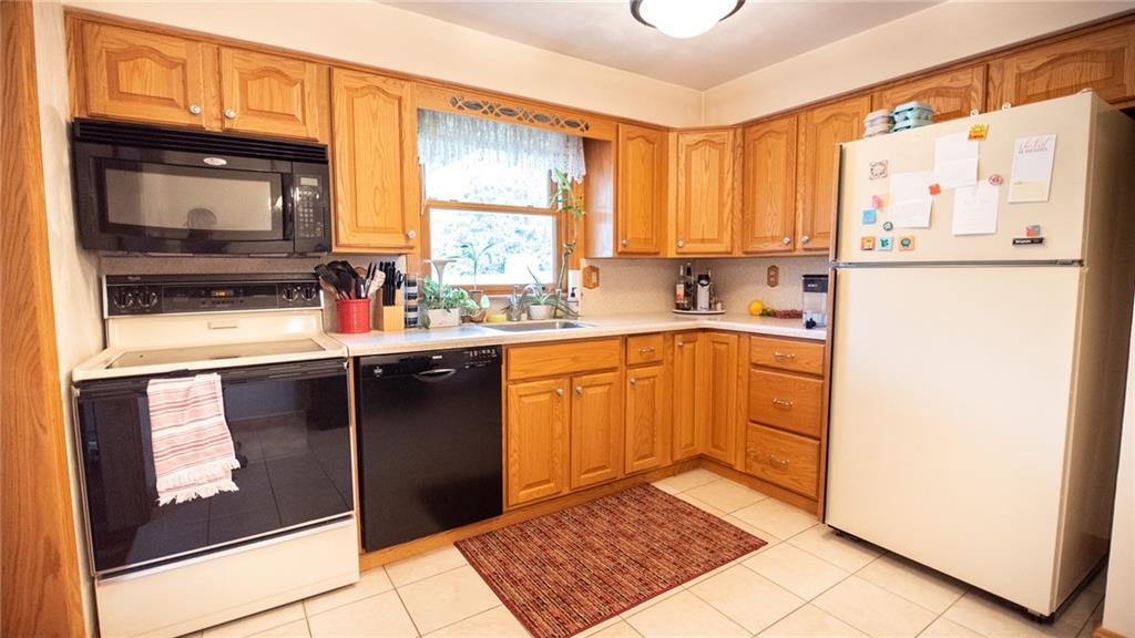 141 Singleton Road Sarver, PA 16055 - Photo 6 of 23 a kitchen with a sink window and cabinets