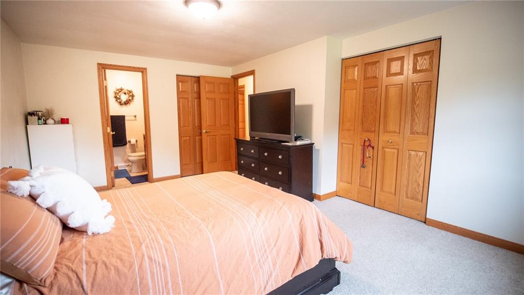 141 Singleton Road Sarver, PA 16055 - Photo 10 of 23 a bedroom with a bed and a flat tv screen on dresser