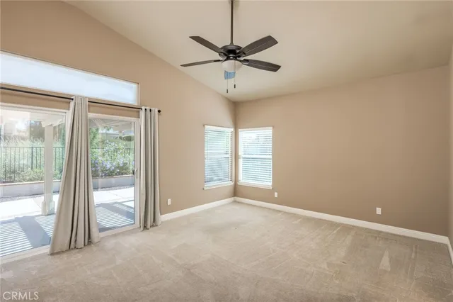 a view of a livingroom with a ceiling fan and window