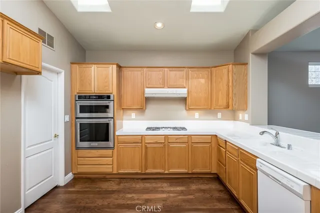 a kitchen with a sink stove and cabinets
