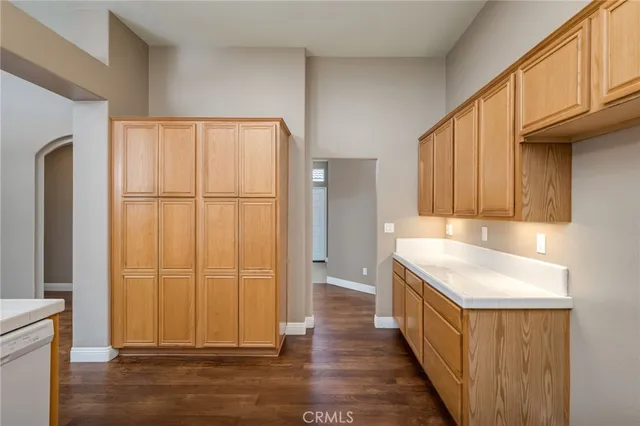 a view of a kitchen with wooden floor and staircase