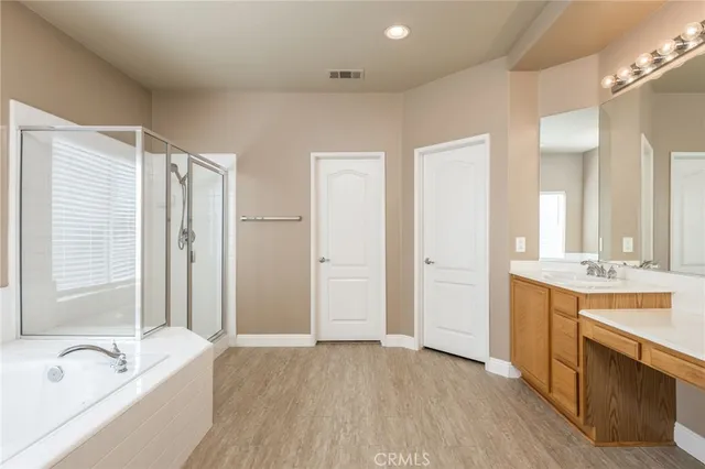 a spacious bathroom with a granite countertop tub sink and mirror